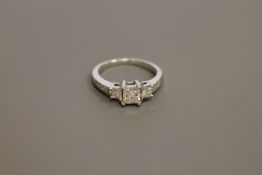 An 18ct white gold three-stone radiant-cut diamond ring,