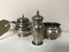 A three piece silver cruet set