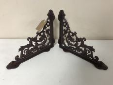 A pair of cast iron rust brackets