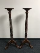 A pair of mahogany torcheres