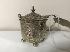 A silver mustard pot with spoon