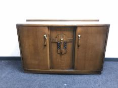 A mid 20th century triple door oak sideboard