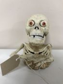 A skeleton cast iron money bank