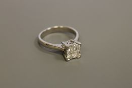 A heavy platinum ring set with four princess cut diamonds, approximately 1.0 carat total weight, 6.
