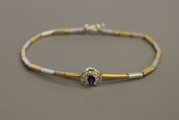 An 18ct white and yellow gold diamond and sapphire set bracelet, 14.