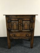 A Chapmans Siesta double door oak cabinet fitted a drawer