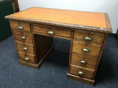 An antique pine writing desk fitted nine drawers