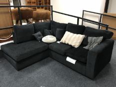 A contemporary corner settee in a black fabric