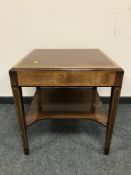 A Victorian style inlaid mahogany book table