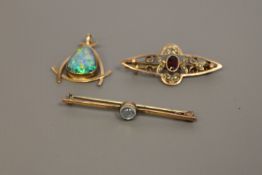Three gold brooches/pendants to include a moonstone bar brooch,