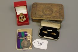 A Princess Mary 1914 Christmas tin, a Royal Army Medical Corps badge,