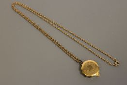 A 9ct gold chain (5.6g), upon which hangs a gilt metal St.