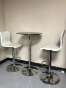 A glass top poser bar table and two high stools
