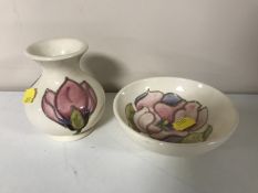 A Moorcroft pottery Magnolia pattern dish and vase (2)