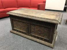 An antique carved oak continental coffer