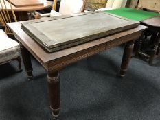 An early 20th century oak pull out table with two leaves