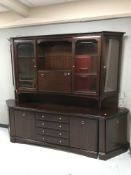 A Stag Minstrel cocktail display unit and a pair of matching corner cabinets