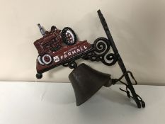 A cast iron farmall tractor bell