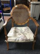 A walnut framed cane backed armchair
