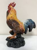 A cast iron painted cockerel figure