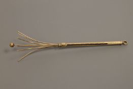 A 9ct gold swizzle stick