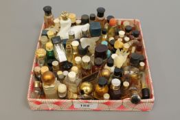 A tray containing a large collection of perfume miniatures