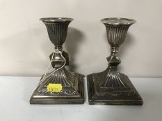 A pair of sterling silver candlesticks on square bases,