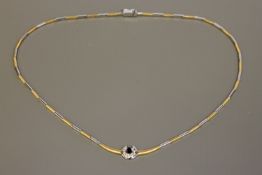 An 18ct white and yellow gold diamond and sapphire set necklace, 26.