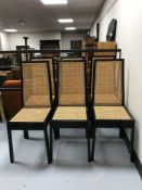 A set of six black gloss and bergere dining chairs