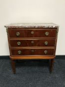 A continental marble topped three drawer chest with brass drop handles