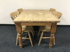 A rectangular pine kitchen table and four chairs