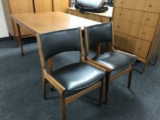 A late 20th century Danish teak pull out table and two chairs
