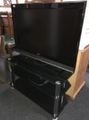 An LG 37 inch LCD TV with lead on stand