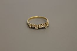 An 18ct gold seven stone diamond ring