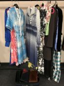 A small quantity of vintage lady's clothing and a suitcase of hand bags