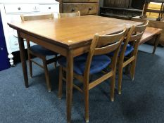 A late 20th century Danish teak pull out table and four chairs