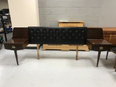 A late 20th century teak black vinyl continental headboard