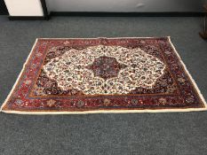 A fringed Persian Kashan rug