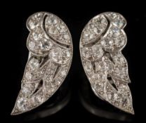 A pair of early 20th century platinum and diamond clip earrings: of wing design,