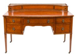 An Edwardian satinwood and chequer inlaid bow-fronted kneehole dressing or writing table:,