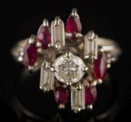 A diamond and ruby eleven-stone cluster ring: the central circular,