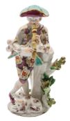A Bow figure of a shepherd musician: standing crossed legged and playing a recorder,