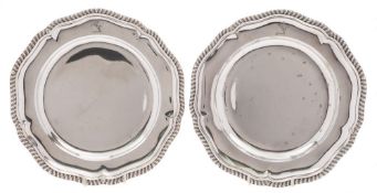 A pair of late Victorian silver dinner plates, maker R & S Garrard & Co, London, 1892: crested,