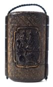 A Japanese four-section lacquer inro: with low relief carved panels of blossoming shrubs,