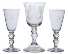 A large presentation wine glass and a pair of wine glasses: the former with bell shaped bowl