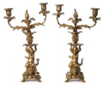 A pair of 19th century ormolu candlesticks: the twin foliate branches with urn shaped nozzles,