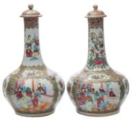 A pair of Canton famille rose bottle-shaped vases and covers: painted with panels of numerous