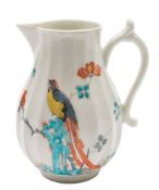 A First Period Worcester milk jug: of fluted form with sparrow beak spout and scroll handle,
