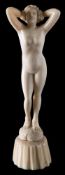 An early 20th century carved ivory figure: of a standing female nude,