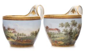 A pair of Meissen cabinet cups: of ogee form with high strap handles and finely painted with